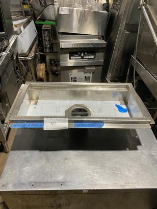 Stainless steel floor trough with drain, used condition, labeled "50 QTY" and "FLOOR TROUGHS," measures approximately 24"x16".