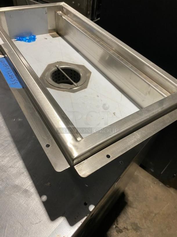 Stainless steel floor drain insert with hexagonal drain cover, used condition, dimensions approximately 24x12 inches.