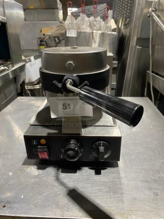 Commercial waffle maker in stainless steel with a black handle, control knobs, and labeled auction number 51. Good condition.