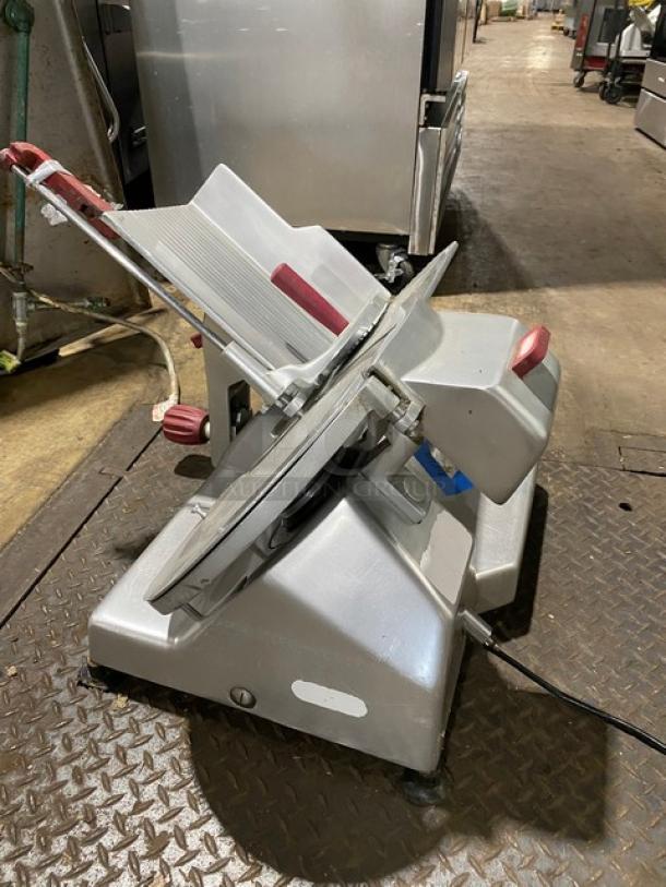 Electric deli meat slicer with stainless steel blade, adjustable thickness, and red safety grip. Used condition.