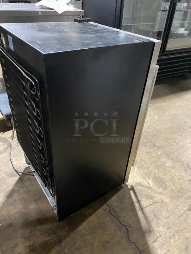 Commercial black refrigeration unit, side view showing coil and wiring. Good condition, minor surface wear.