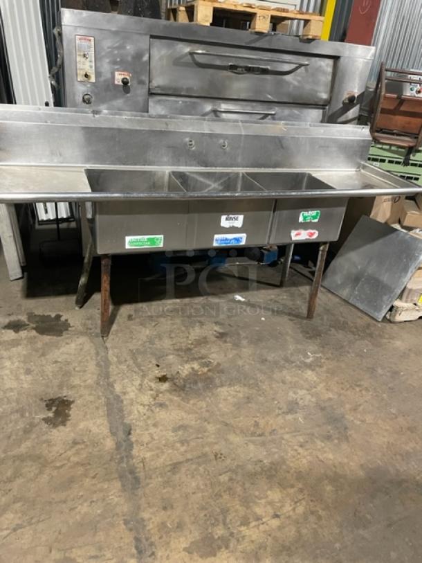 Commercial stainless steel 3-compartment dishwashing prep sink with left & right drain boards, backsplash, on legs.