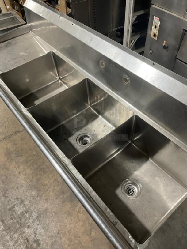 Commercial stainless steel 3-compartment sink with left and right drain boards, backsplash, and legs. Excellent condition.