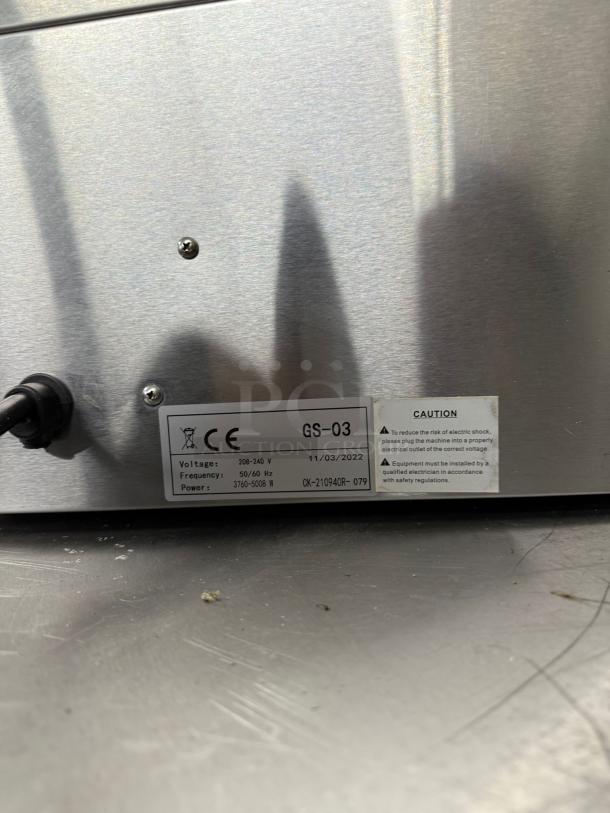 Metal appliance with label showing model GS-03, voltage 208-240V, power 3760-5000W, manufactured on 11/03/2022.