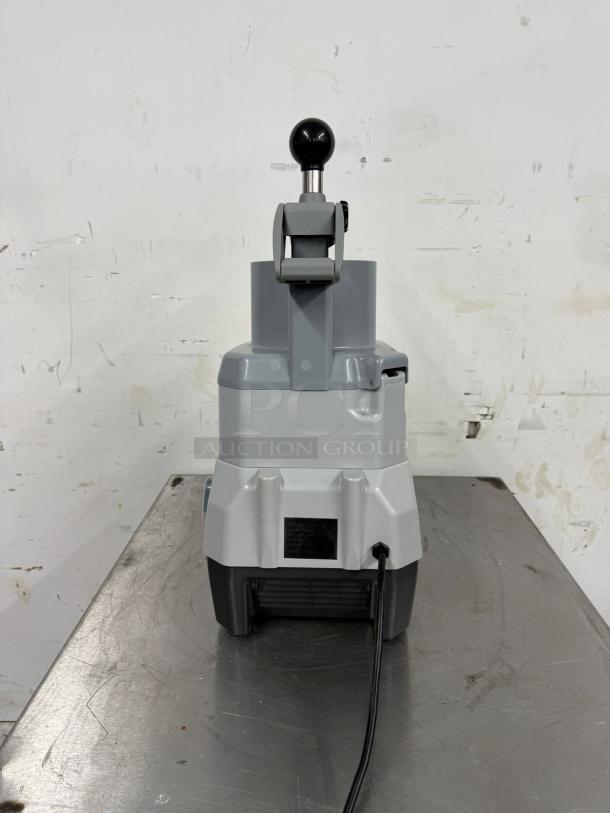 Commercial ice shaver machine in used condition, features a sturdy gray and black design with visible power cord and handle.