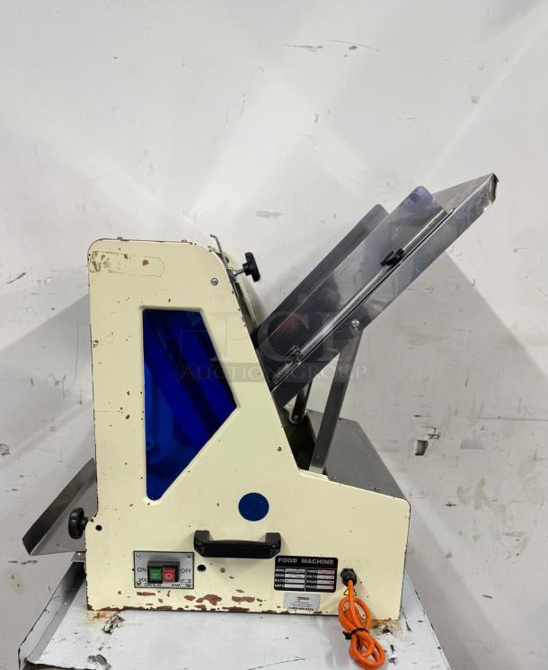 Vintage food machine with metal chute, visible wear, model SXJ-6. Features on/off switch, orange power cord.