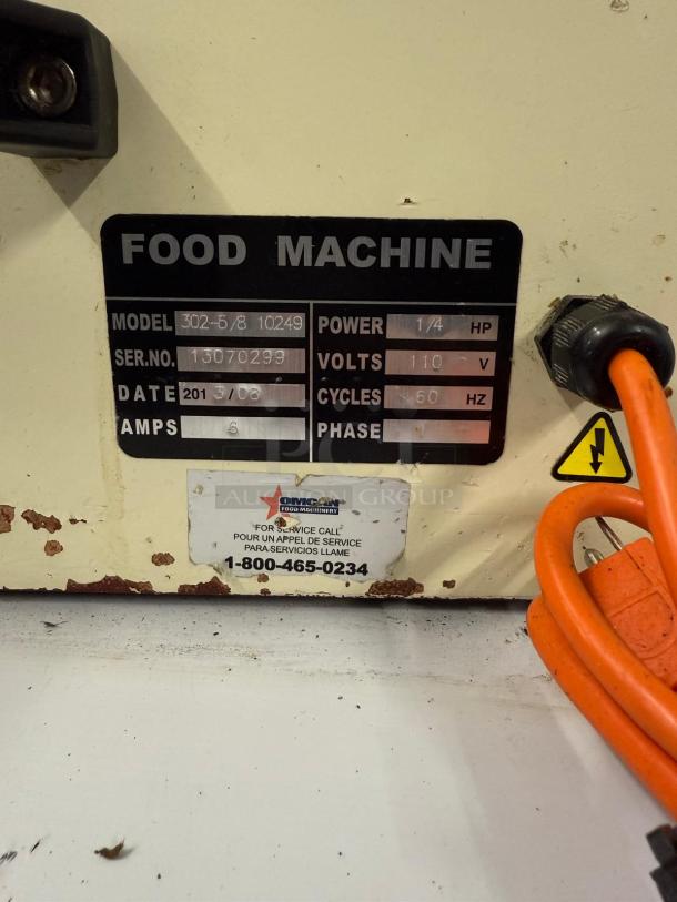 Food machine with model 302-5/8 10249, 1/4 HP, 110V, 60Hz. Serial 13070299. Visible wear, service label with contact number.