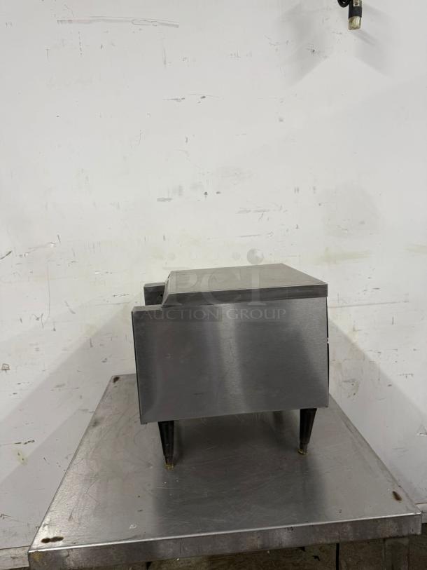 Stainless steel countertop appliance with adjustable legs, used condition, suitable for restaurant kitchen setup.