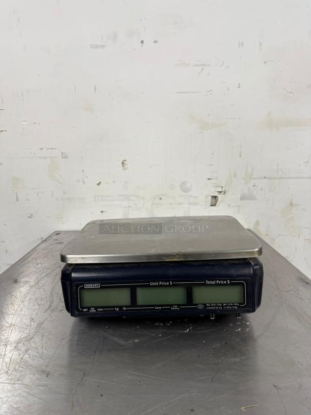 Hobart digital weighing scale with a stainless steel platform, dual displays for unit and total price. In used condition.