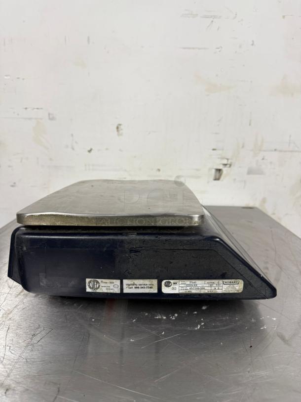 Vintage Hobart PS40 weighing scale, black body with metal top. Labels show model and warranty service details. Fair condition.