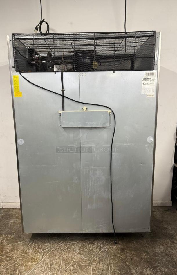 Commercial refrigeration unit with visible wiring and compressor. Metal exterior with manufacturer labels, indicating model and specs.