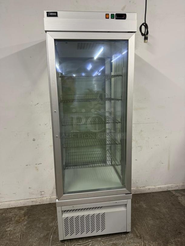 Commercial stainless steel glass-door refrigerator. Features multiple wire shelves, visible control panel, and power cord.