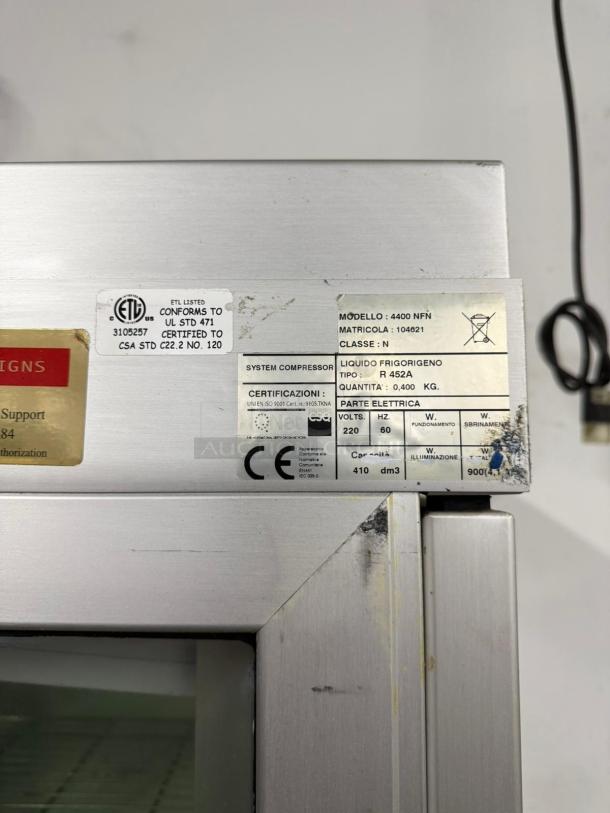 Commercial refrigerator with metal surface, visible labels indicate model 4400 NFN, uses R 452A refrigerant, and meets ETL, CE standards.
