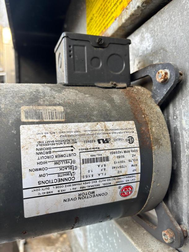 Convection oven motor with rust and wear. Label shows AMBAC model AJ4Z1989, 115V, 50/60Hz, 1725 RPM, 1/3 HP.
