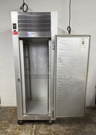 Traulsen commercial refrigerator, stainless steel, single-door, on wheels, visible control panel and internal shelving, good condition.