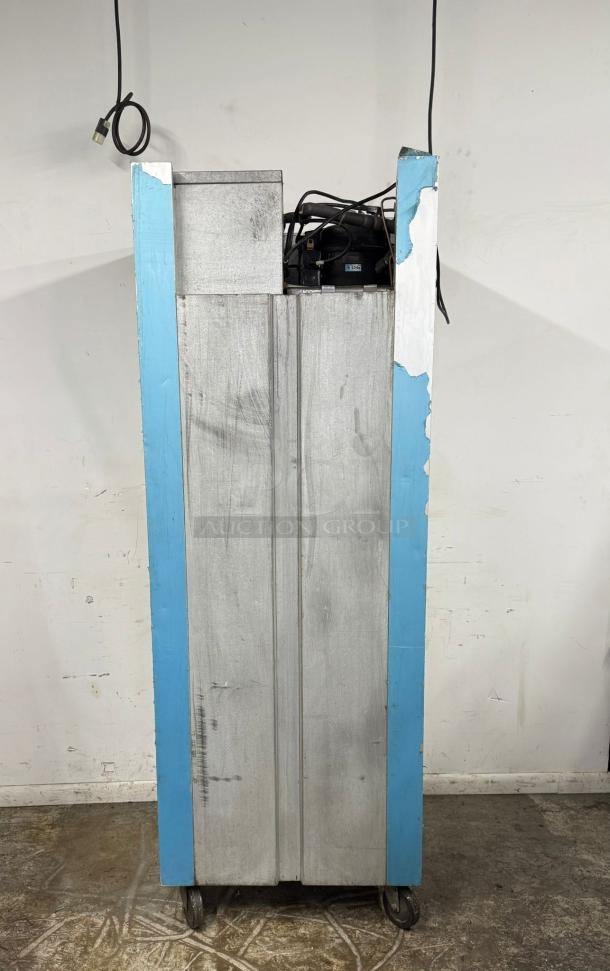 Industrial metal storage unit on wheels, worn blue trim, visible power cords, showing signs of wear.
