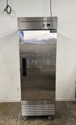 Dukers stainless steel commercial refrigerator with digital display, lock, and wheels. Warranty tag visible. Excellent condition.