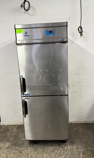 Stainless steel ColdTech commercial freezer, double door, digital display, visible dents, green caution label.