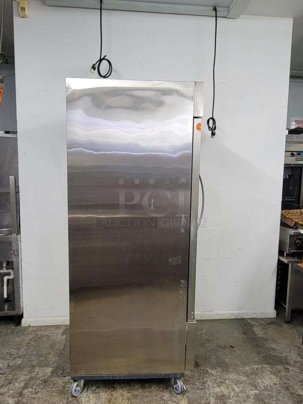 Commercial stainless steel refrigerator on wheels, excellent condition, no visible brand, with power cables connected.