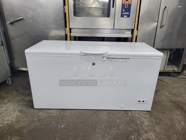 White chest freezer in good condition, with visible control panel and safety label. Ideal for bulk storage needs.