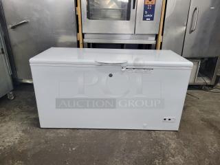 White chest freezer in good condition, with visible control panel and safety label. Ideal for bulk storage needs.