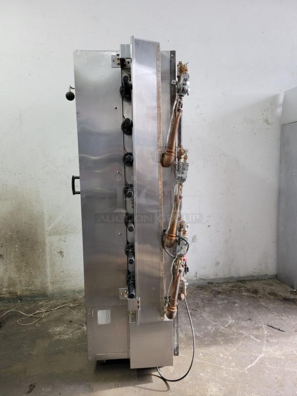 Stainless steel industrial machine with visible pipes and controls, used condition. Ideal for manufacturing or processing.