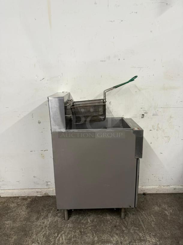 Commercial deep fryer with basket, stainless steel, good condition. Perfect for high-volume use. No visible markings.