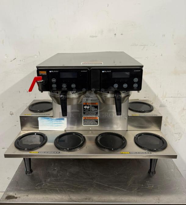 Bunn Axiom dual coffee brewer, stainless steel, multiple warming plates, digital controls, excellent condition, warning labels.