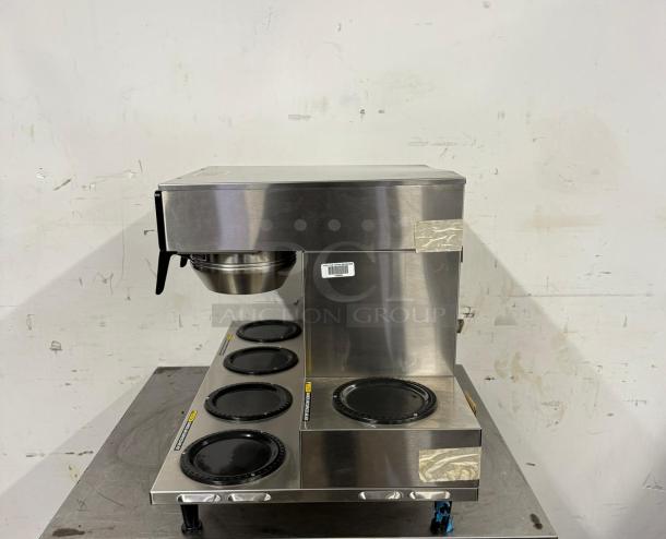 Commercial coffee maker with five burners and stainless steel finish. Appears in good condition. Barcode label attached.