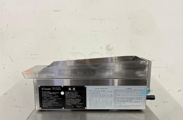 Stainless steel Dukers griddle, model DCFGS12, in good condition. Features manual controls, safety labels, and installation instructions.