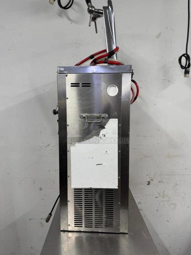 Commercial beer tap dispenser with hoses, stainless steel body, minor wear, vented panel, visible mounting handle.