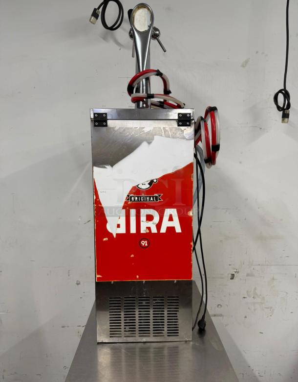 Vintage soda dispenser machine, red and stainless steel, marked "Original Gira," visible wear, resting on a metal surface.
