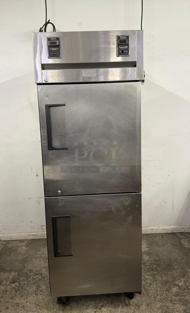 True stainless steel commercial refrigerator, double-door, top-mounted temperature controls, used condition.