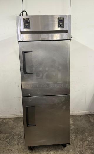 True stainless steel commercial refrigerator, double-door, top-mounted temperature controls, used condition.