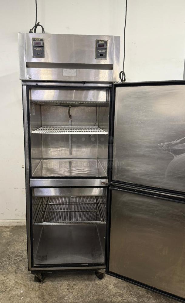 Commercial stainless steel double-door refrigerator; True brand, digital displays, interior shelves, casters, good condition.