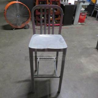 Aluminum bar height patio chair with slatted back, grey finish. Sturdy frame, suitable for outdoor use. Condition appears good.