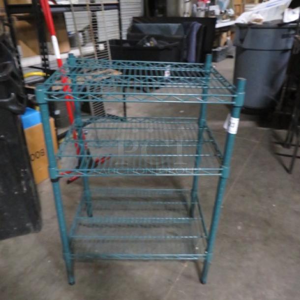 Green coated Metro shelf, 3-tier, 24x18x36 inches, excellent condition. Ideal for storage, durable wire construction.