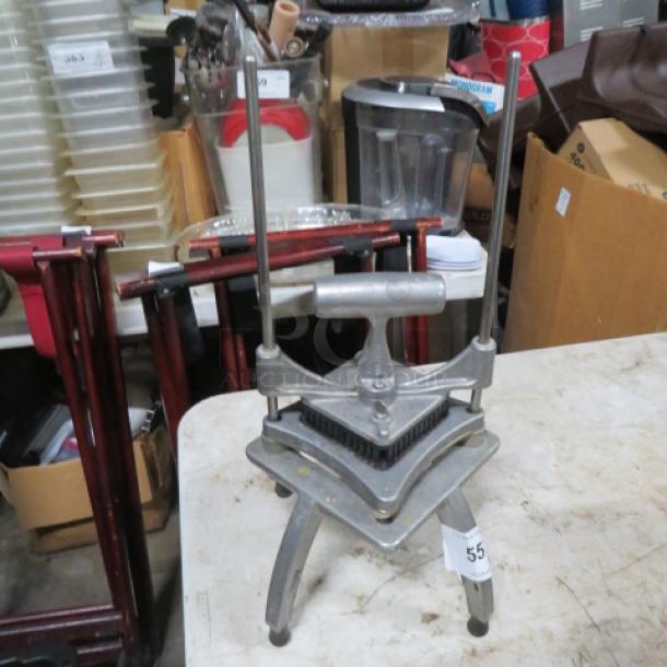 Nemco vegetable cutter, metal construction, manual operation with dual vertical rods, sturdy rectangular base, item tag visible.