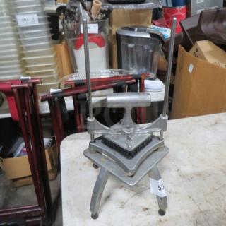 Nemco vegetable cutter, metal construction, manual operation with dual vertical rods, sturdy rectangular base, item tag visible.