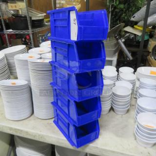Blue Akro Bin 5XBID stackable storage containers, six units, sturdy plastic, slight wear. Ideal for organizing tools or parts.