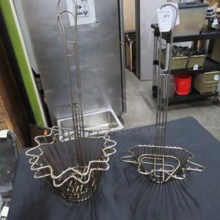 Assorted taco shell deep fry baskets, metal, set of two, with handles. Used condition, suitable for commercial kitchens.