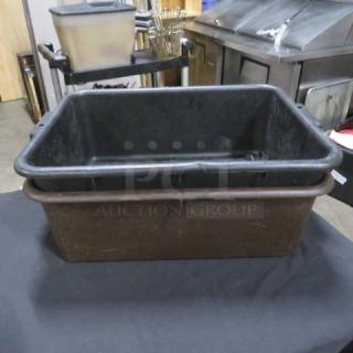 Black plastic bussing tub with sturdy handles, used for clearing dishes, in fair condition.