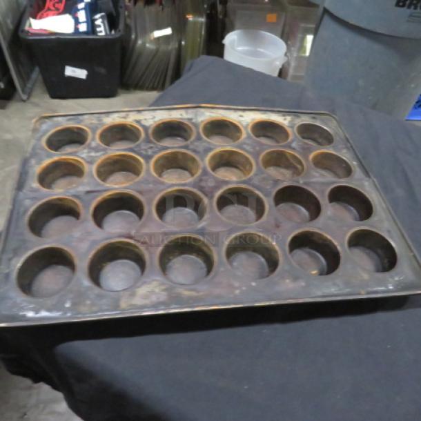 24-hole commercial muffin pan, used condition, metal construction. Ideal for high-volume baking. Model 2XBID.