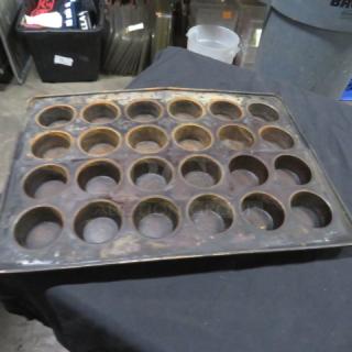 24-hole commercial muffin pan, used condition, metal construction. Ideal for high-volume baking. Model 2XBID.