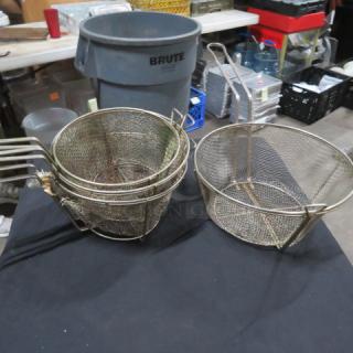 Set of four metal fry baskets, used condition. Various sizes, with wire mesh and handles. Ideal for commercial kitchen use.