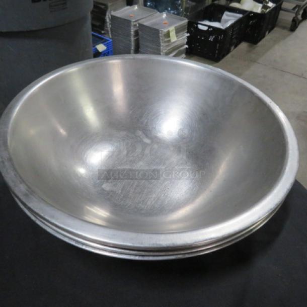 12-inch stainless steel mixing bowl in good condition, slightly polished finish, no visible dents or scratches.