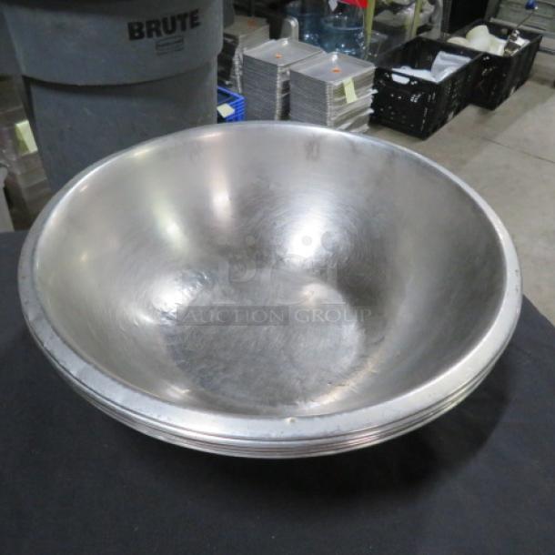 13-inch stainless steel mixing bowl, gently used, with minor surface scratches. No visible tags or markings.