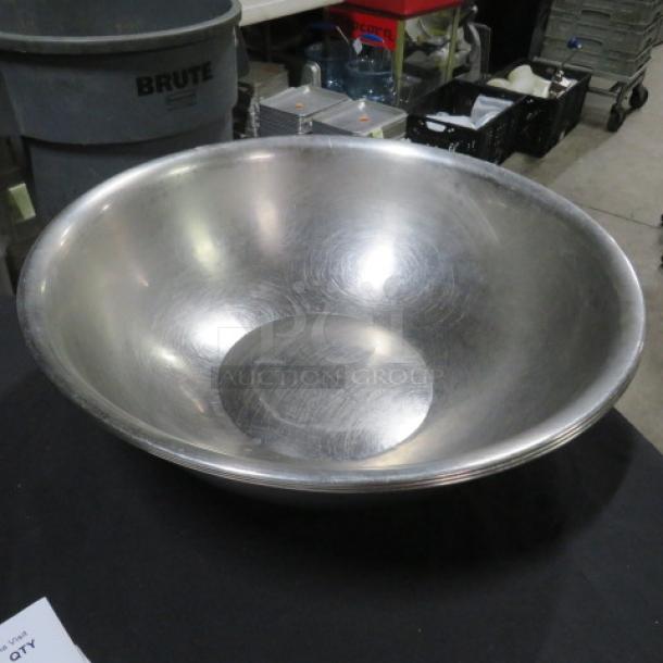18-inch stainless steel mixing bowl with brushed finish, minor surface scratches, marked "3XBID," excellent for kitchen use.