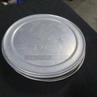 Set of five 10-inch pizza pans, aluminum, stacked, used condition, no visible markings, ideal for baking.