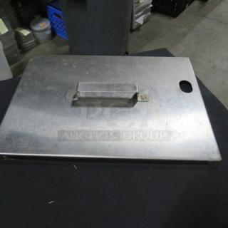 Square stainless steel lid, 15.5x11 inches, with handle and hole. Slight wear visible. Durable and versatile kitchen accessory.